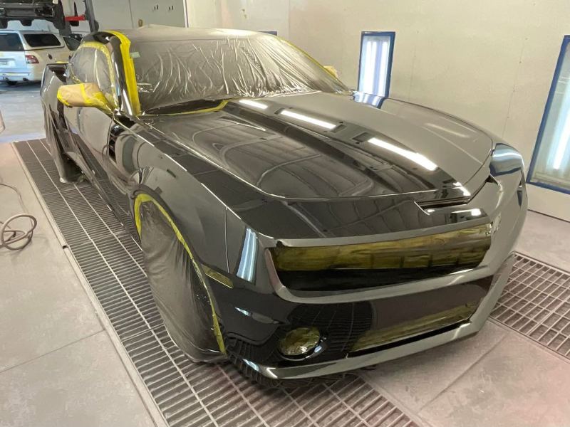 Front corner of the Camaro in the spray booth after painting