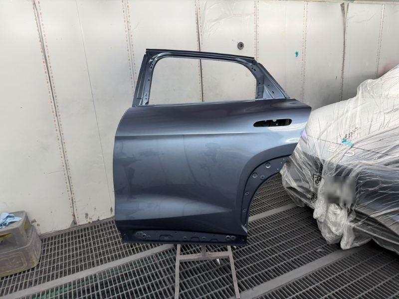 Rear door refinished off the car on a stand in the spray booth