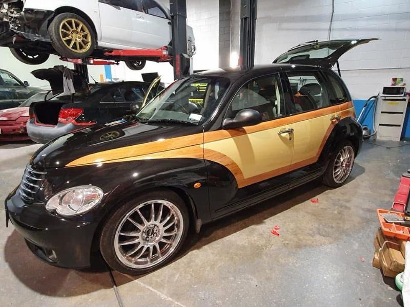 Finished PT Cruiser with custom woodie panels in the workshop